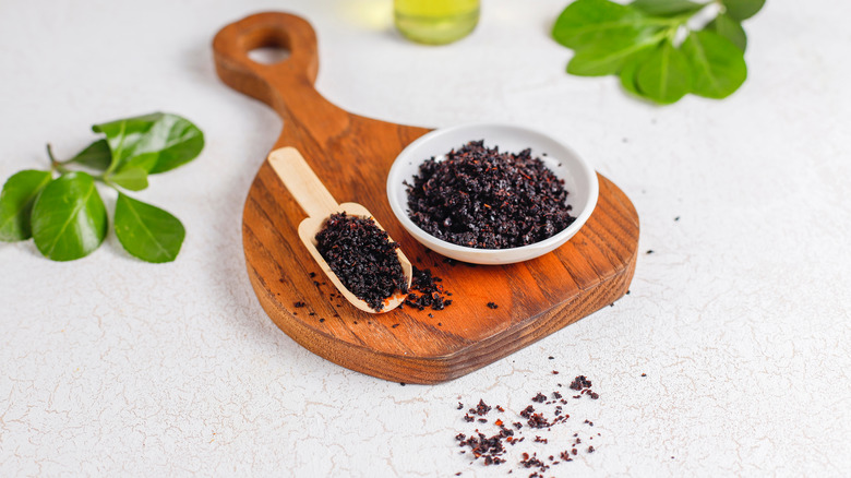 Urfa biber in a bowl and in a spoon on a board