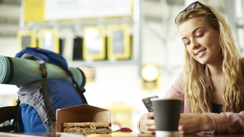 Woman eating food at airport