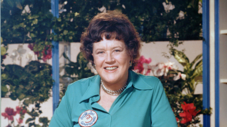 Julia Child smiling, wearing blue blouse