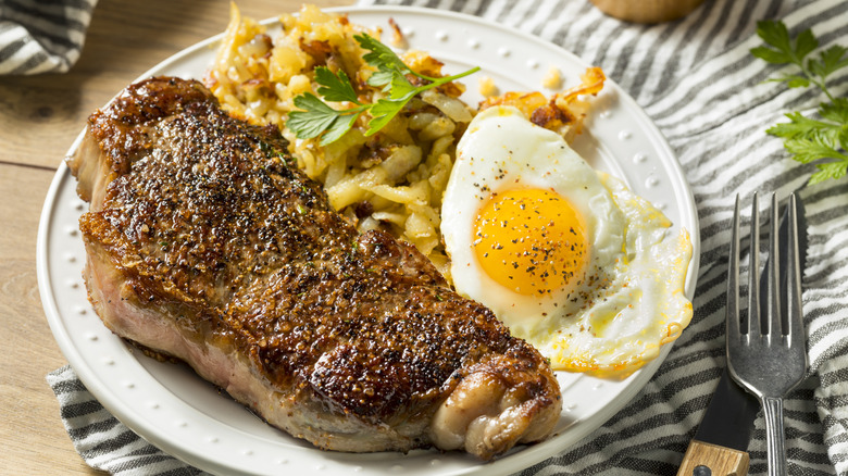 Steak and eggs plate with breakfast potatoes