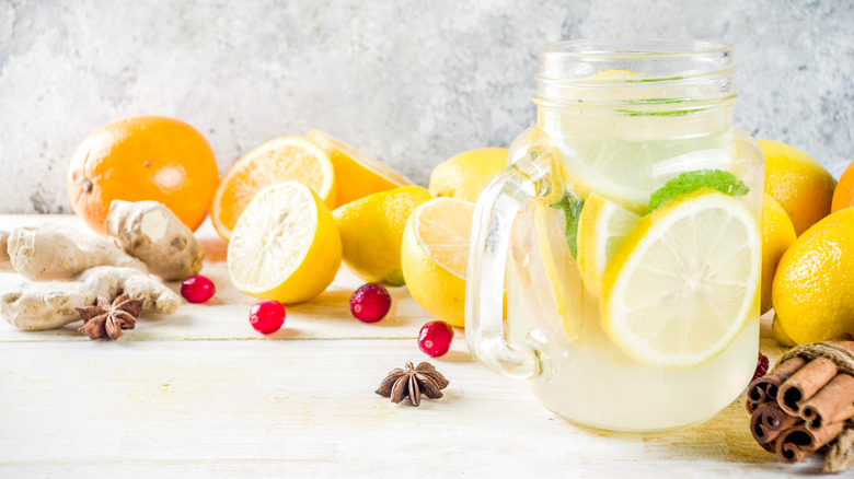 a glass of spiced lemonade with lemons, ginger, cinnamon, and star anise