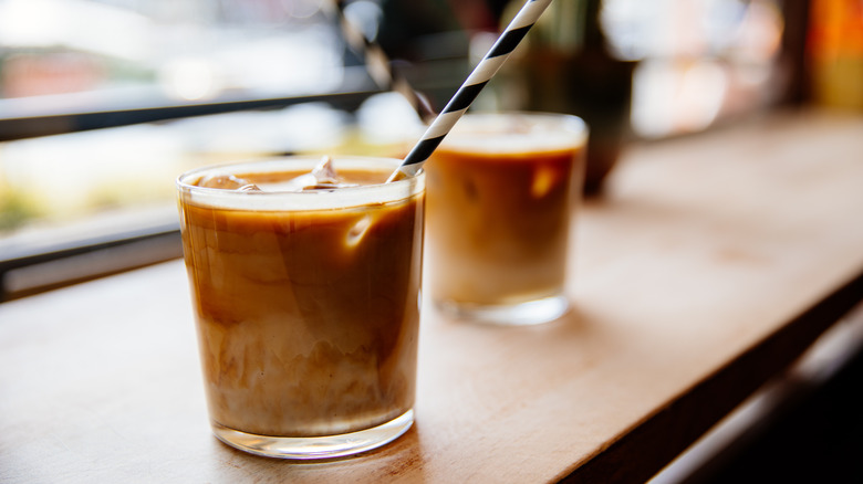 Cups of iced coffee with straw