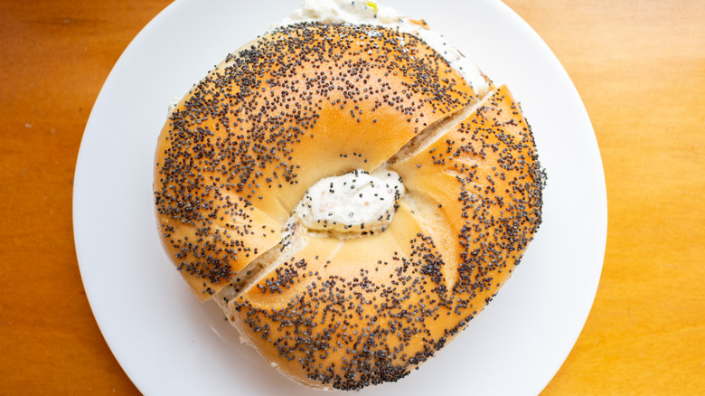 Bagel with cream cheese on plate