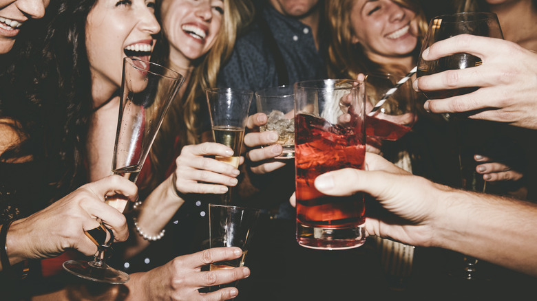 Friends laughing and enjoying cocktails at a bar