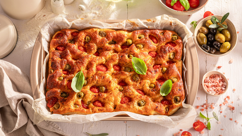 A homemade focaccia with tomatoes and olives.