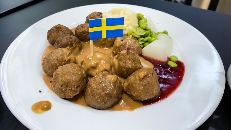White plate with Ikea Swedish meatballs, gravy, lingonberry jam, potatoes