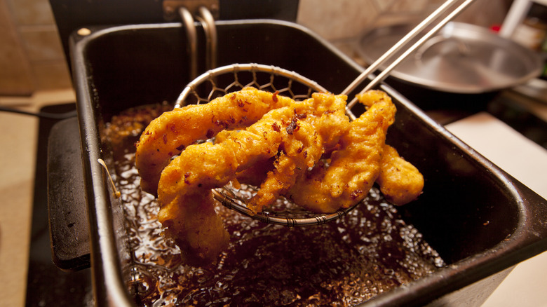 Chicken tenders pulled from fryer