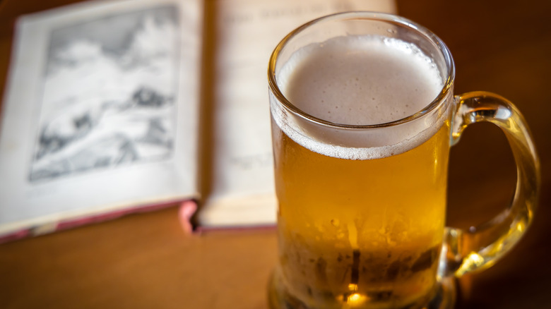 Mug of beer and open book