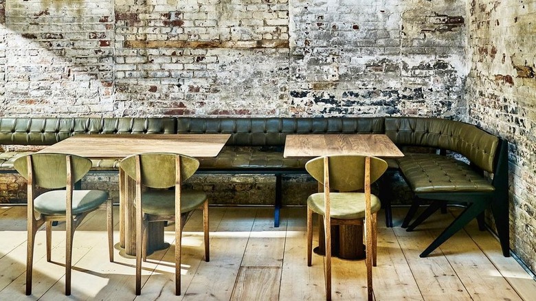 banquettes and tables exposed brick walls