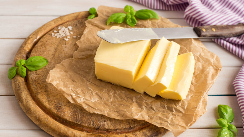 Slab of butter on plate with knife