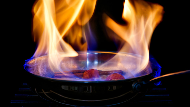 Flambeing peaches in a pan