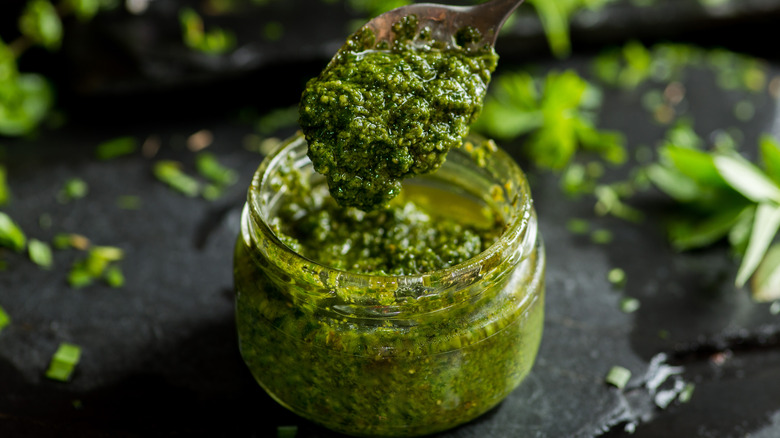 Pesto in a jar with a spoon