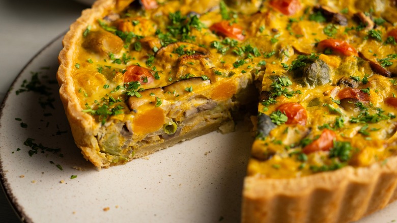 Vegetable quiche with slice removed