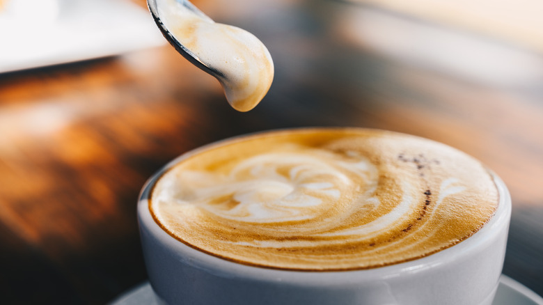 a cappuccino with a spoon