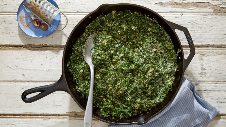 Creamed spinach in pan with nutmeg