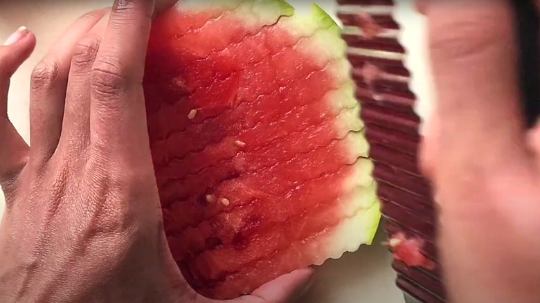 person cutting up watermelon fries