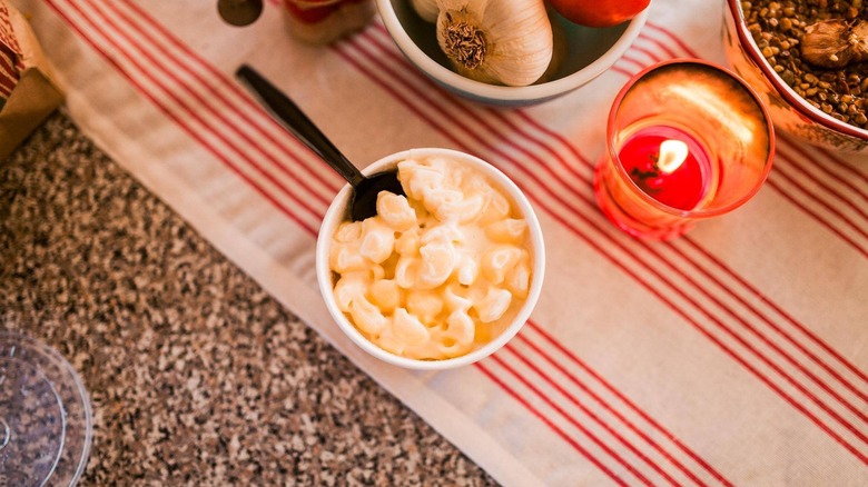 Panera mac and cheese next to a candle