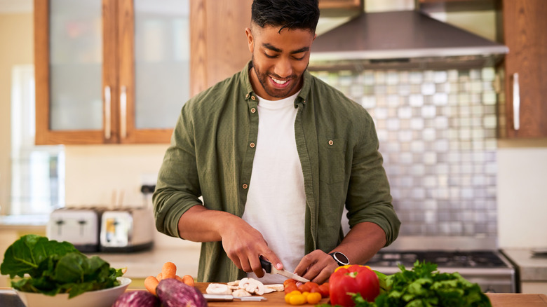 Man chopping raw vegetables