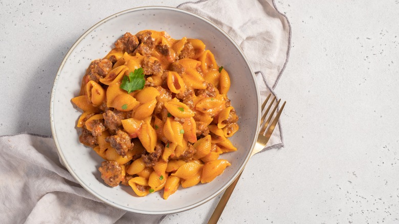 Pasta shells with meat sauce in white bowl