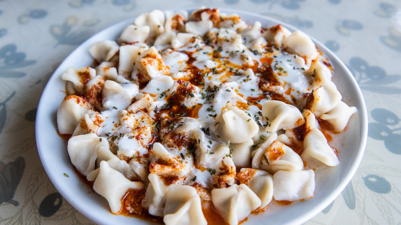 Turkish manti dumplings with yogurt sauce and spiced oil