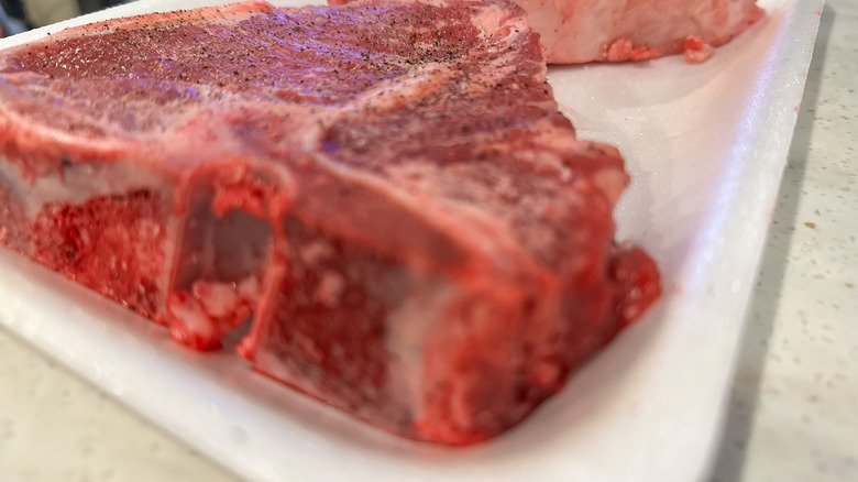 A raw steak can be viewed up close, revealing its thickness