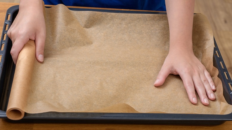 person lining baking tray