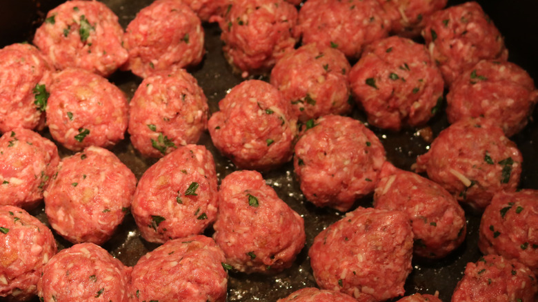 meatballs searing in a pan