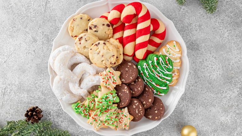 Plate of assorted festive cookies including green Christmas tree cookies