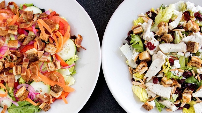 Two plates of salad at Tom & Chee