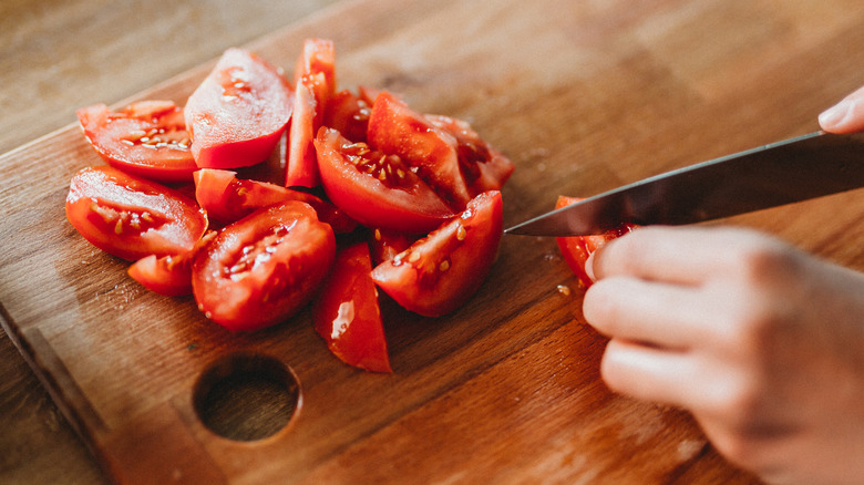 slicing tomatoes on cutting board