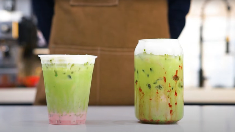 Two green tea matcha drinks with strawberry and cream