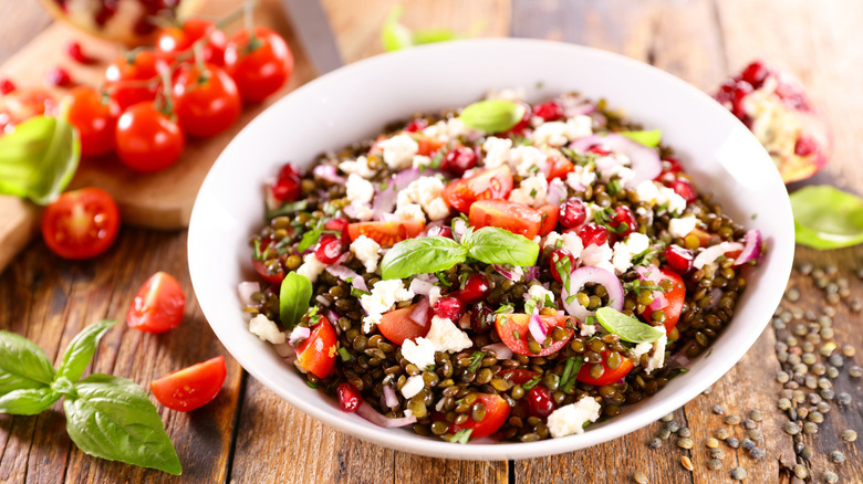 A lentil salad with tomatoes, basil, feta, and onions