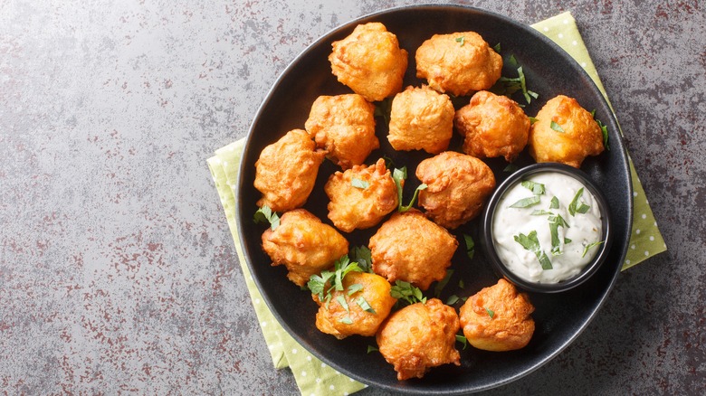 Plate of hush puppies with creamy dipping sauce