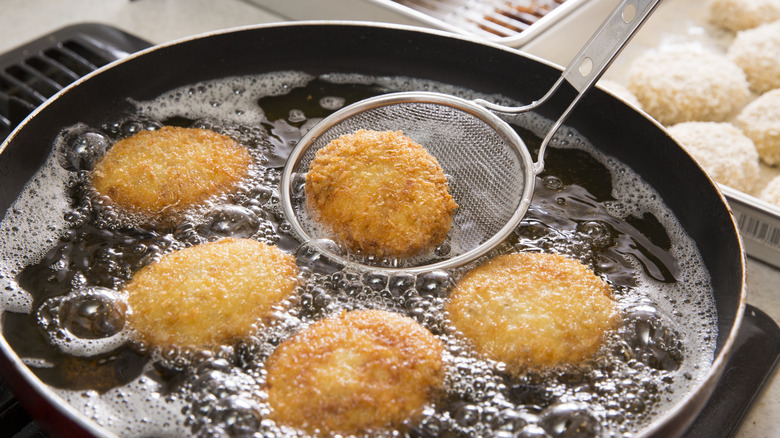 Frying croquettes in frying pan