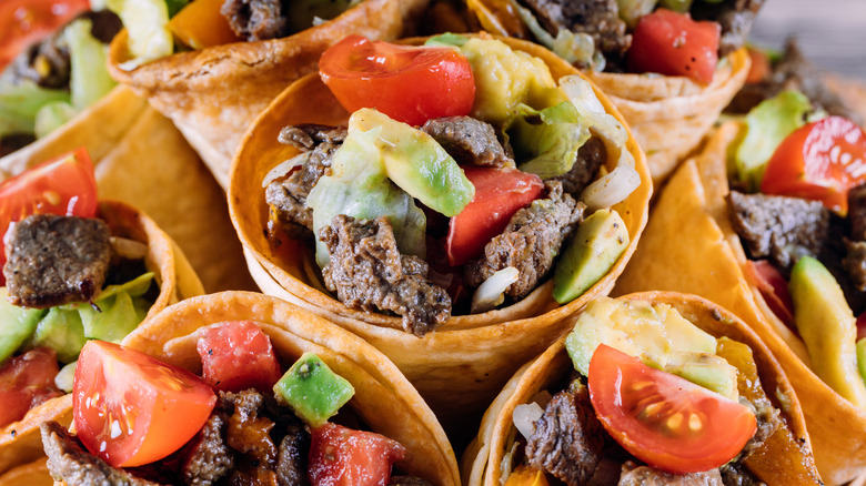 Fajita fried tortilla cones with meat avocado and tomatoes