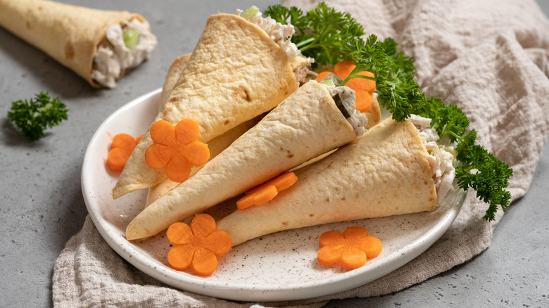 Crispy baked tortilla cones stuffed with chicken salad on plate