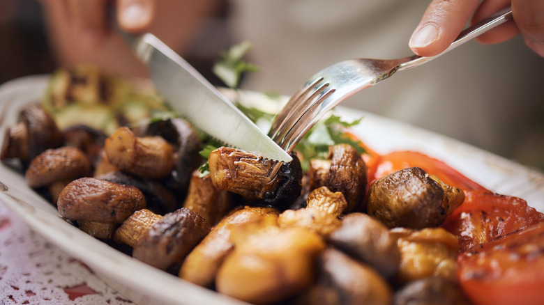 cutting roasted mushrooms