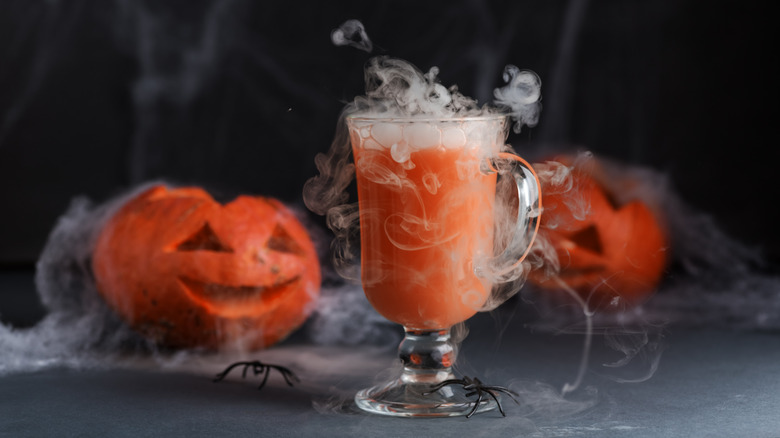 Jack-o'-lanterns and halloween drink with dry ice