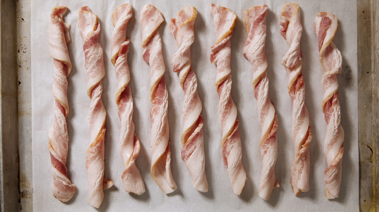 Raw bacon twists before being cooked