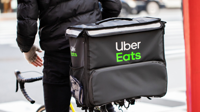 person on bicycle with Uber Eats delivery bag