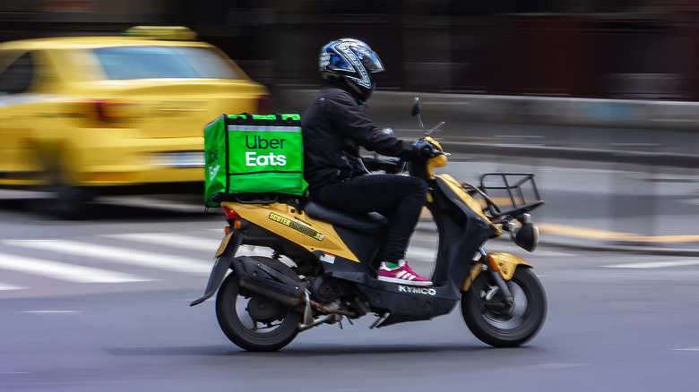 UberEats food delivery worker on scooter