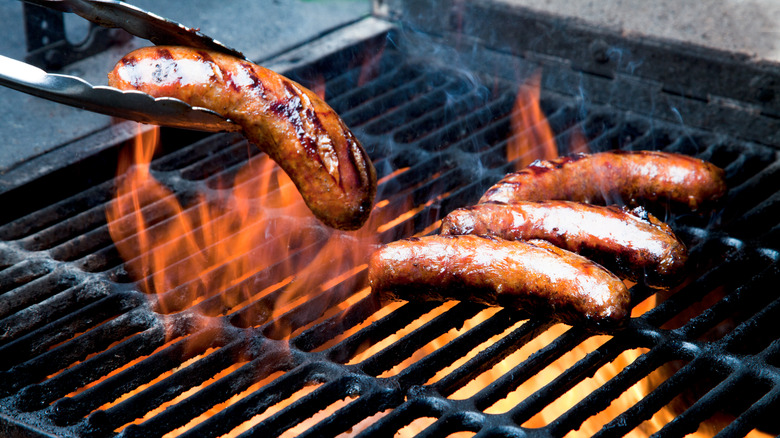 brats on flaming grill