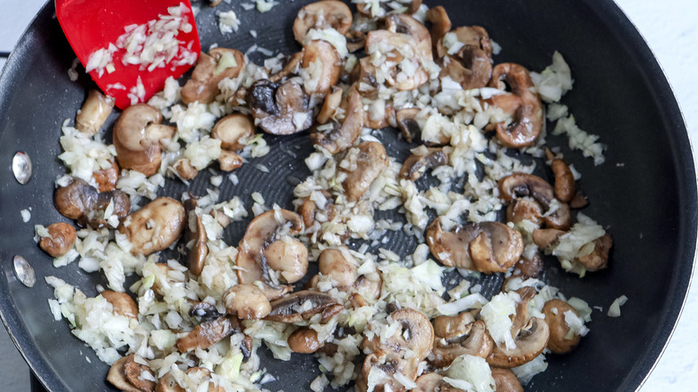 mushrooms and onions in frying pan