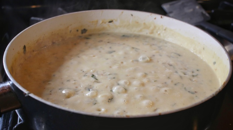 bubbling creamy sauce in pan