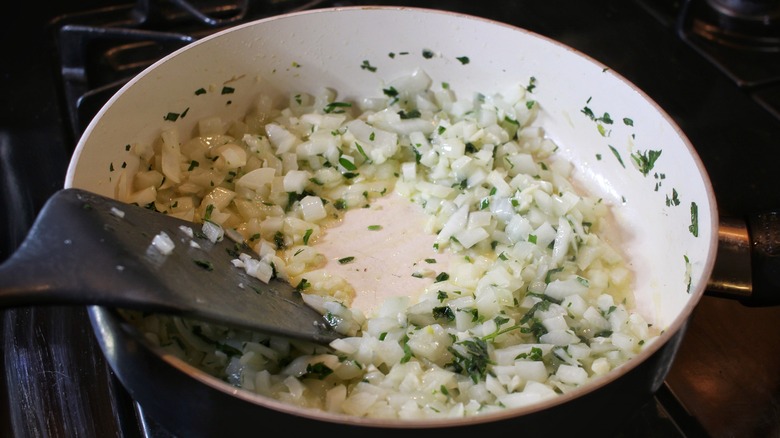 onions garlic parsley in pan