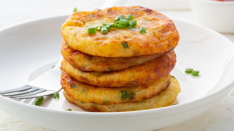 Stack of potato pancakes in white bowl