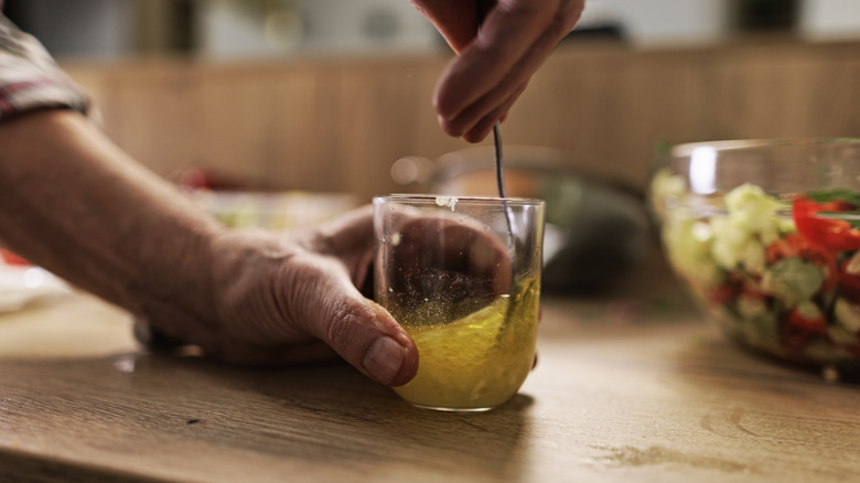 person preparing a fresh vinaigrette