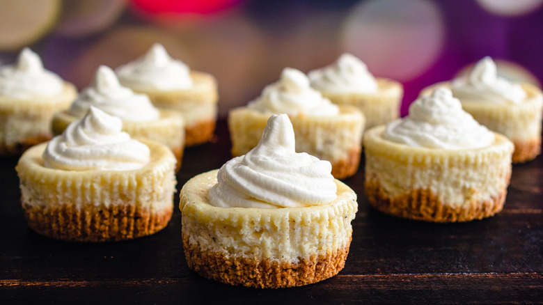 Mini cheesecakes topped with whipped cream