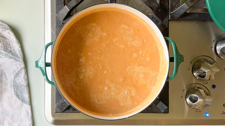 Vegan pumpkin pecan rice pudding simmering on stove