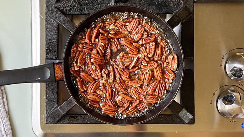 Maple glazed pecans cooking in pan